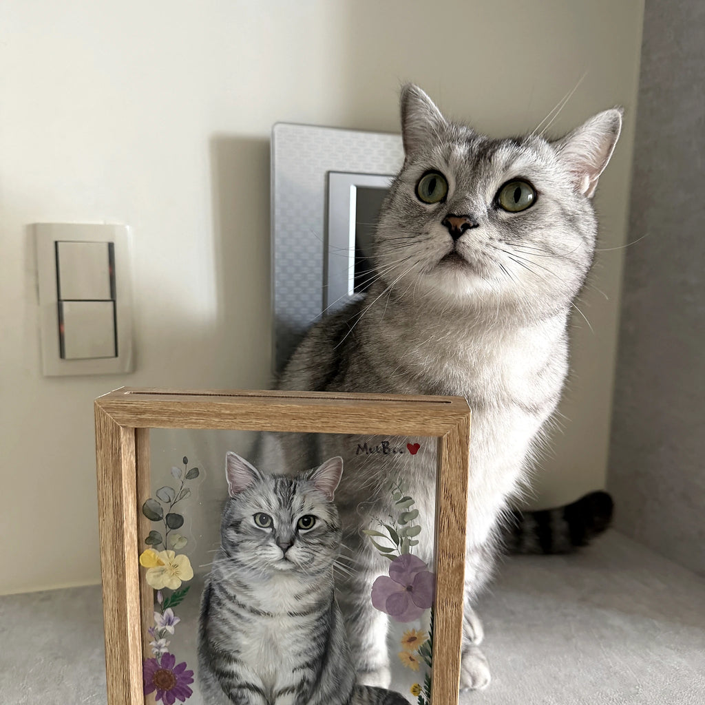 Cat beside a custom pet portrait frame displayed at home